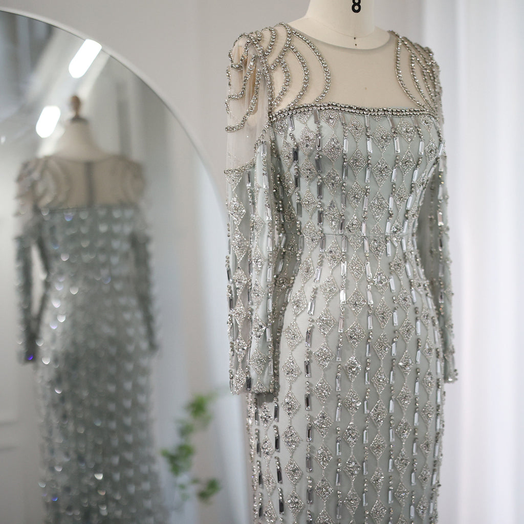 Silver beaded evening gown on a mannequin with a mirror reflection.