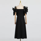 This French-inspired maxi dress features a striking one-shoulder design with floral patchwork and a fitted waist. eprolo