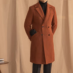 Brown overcoat worn by a person against a beige curtain background