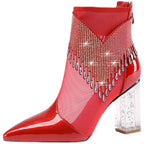 Red patent leather ankle boot with rhinestone embellishments on a white background