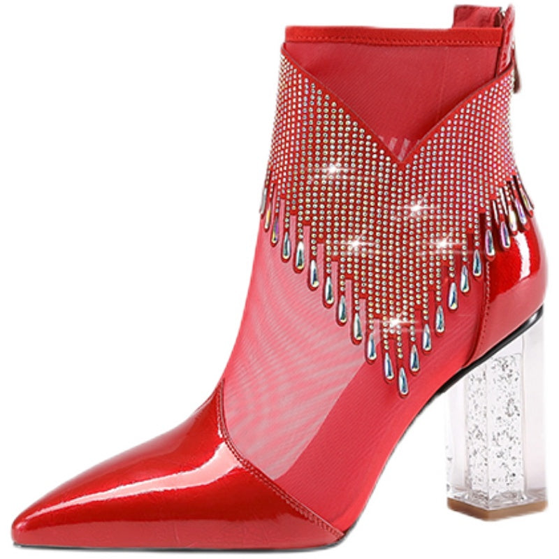 Red patent leather ankle boot with rhinestone embellishments on a white background